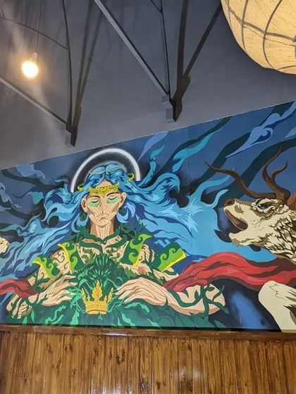 Another perspective of the Mysore mural, showing how it integrates with the cafe's lighting and architecture.