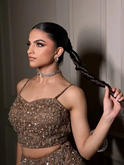A powerful smokey glam look, paired with a dramatic braided ponytail. This is for the bride who wants to make a statement.
