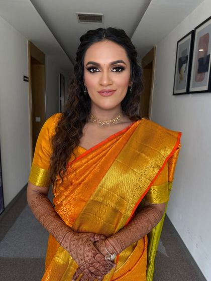 A fresh, golden, glowing look. We paired a soft brown smokey eye with a nude lip and styled her hair in messy, open curls for a relaxed yet traditional vibe.