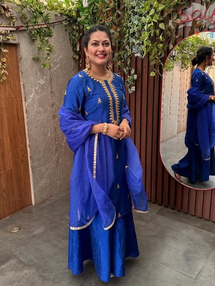 A full view of Priyanka Barve's royal blue concert attire, showing the flow of the sharara pants and the matching dupatta.