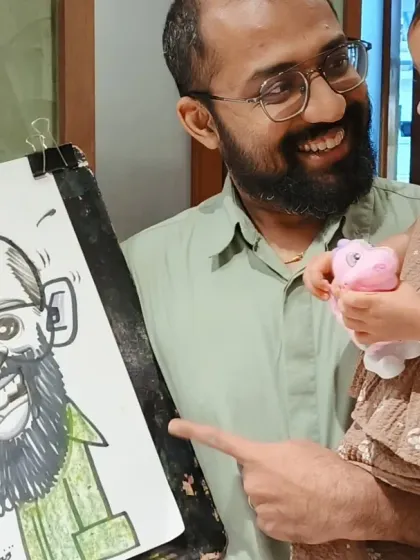 A father and his young child admiring his new caricature. It's a heartwarming moment to witness.