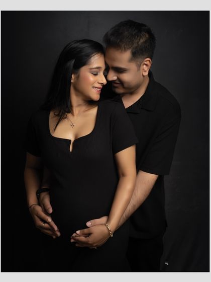 A loving gaze between partners. This intimate black and white photo beautifully captures the connection and shared anticipation of the couple.