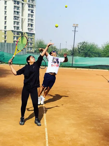 A fun, candid moment on the court with two of my students. We believe in working hard and having fun.