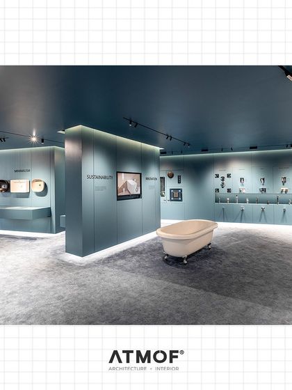 A wide shot of the Vitra showroom floor, showing the overall spatial arrangement. The design encourages movement and exploration while maintaining a consistent and powerful brand atmosphere throughout.