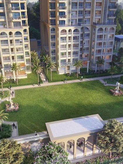 An aerial view of a group housing project in Ghaziabad, blending Classical Roman style with modern amenities. The landscape design reflects this fusion with symmetrical layouts, a grand central lawn, and luxurious facilities.