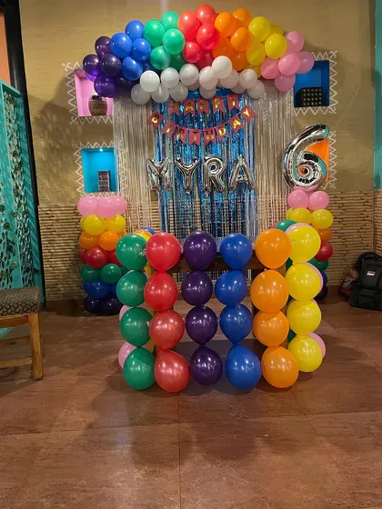 A vibrant rainbow-themed birthday decoration. I used balloons of every color to create a cheerful backdrop, perfect for a fun and lively party for a 6-year-old.