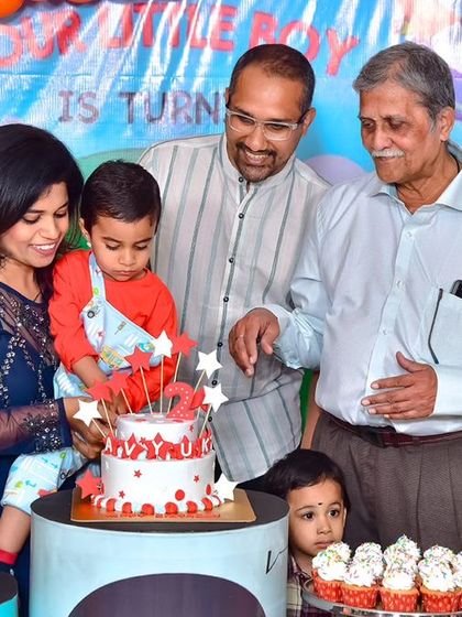 A charming 'Little Man' themed first birthday party, with a sophisticated black and white color scheme, mustache props, and a stylish backdrop, perfect for a dapper celebration.