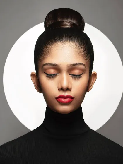 Here, I experimented with a background light to create a halo effect. This adds a graphic, almost spiritual element to the portrait, turning a simple headshot into a more artistic and conceptual piece.