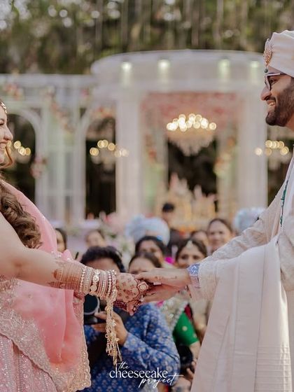 The couple holding hands for the first time on their wedding day.