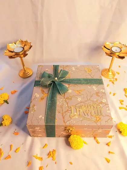 This elegant birdie-print box is a beautiful way to gift dry fruits for Diwali. The box itself is a keepsake, and it comes with two golden lotus T-light holders.