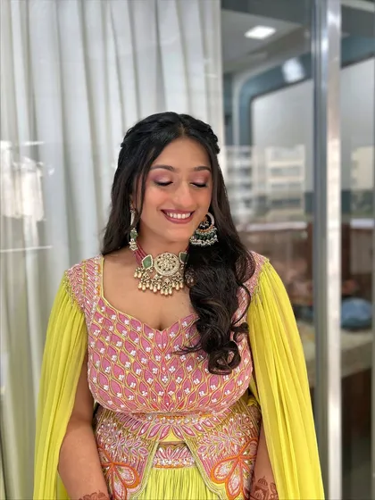 A beautiful smile completes this soft glam look. The makeup is focused on clean skin and shimmery pink eyeshadow, which makes her eyes pop while still looking natural and elegant.