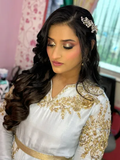 A beautiful look for a sister's baby shower, featuring side-swept waves and a sparkling hair clip.