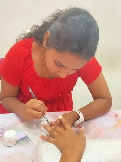 A close-up of a student applying acrylic, demonstrating the precision taught in our professional nail extension course.
