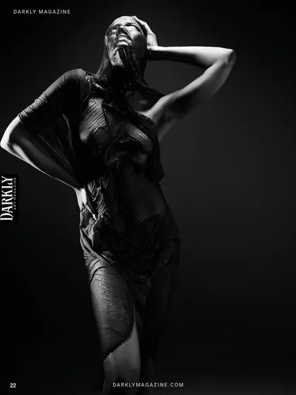 From the "Elegy in Motion" series. This black and white image is all about form and texture. The light rakes across the fabric, revealing its details, while the model's body becomes a sculptural element in the darkness.