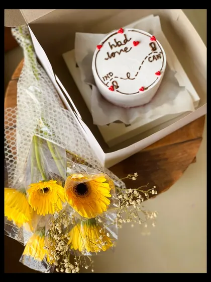 A perfect gift for a long-distance relationship. This hamper includes a bento cake with a cute map design from India to Canada, paired with a bouquet of bright yellow gerberas.