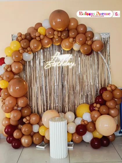 The same earthy-toned setup, but with a 'Happy Birthday' neon sign added for a modern touch.