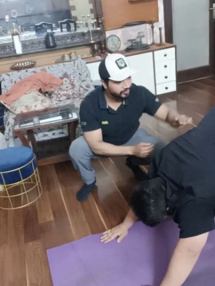 Demonstrating the next move and providing constant feedback during a one-on-one session at a client's home.