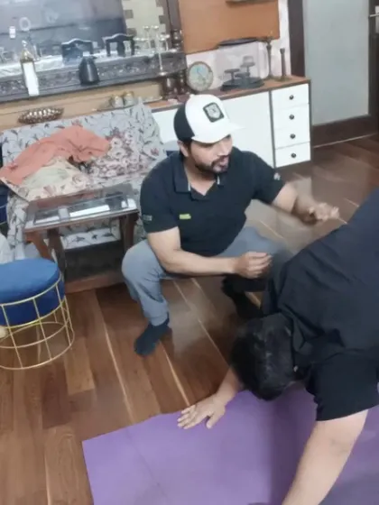 Demonstrating the next move and providing constant feedback during a one-on-one session at a client's home.
