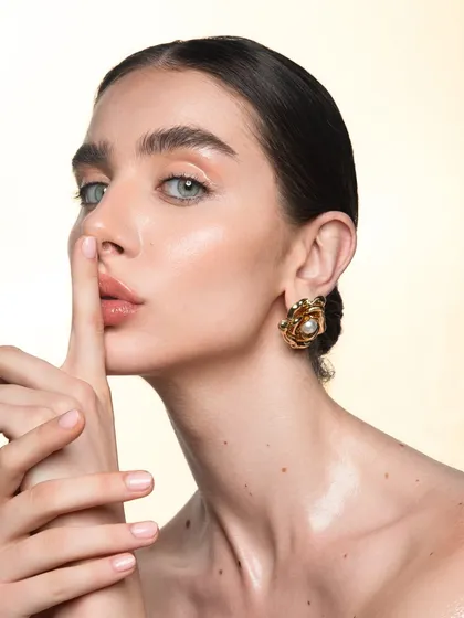 A classic beauty pose that highlights the clean makeup and slicked-back hair. This polished look is perfect for luxury brand campaigns that require an air of sophistication.