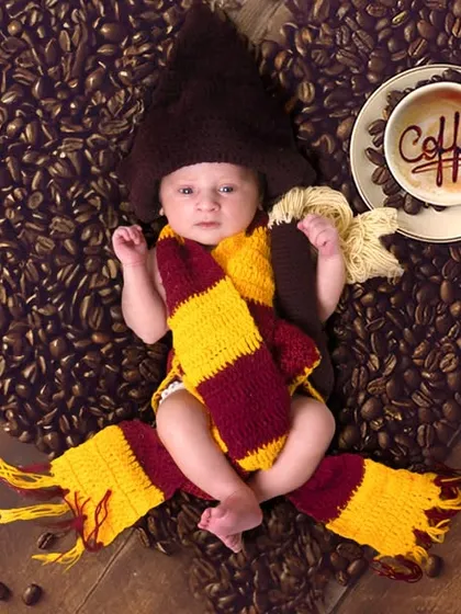 For the fans. A creative Harry Potter themed newborn shoot, complete with a Gryffindor scarf and a heart made of coffee beans.