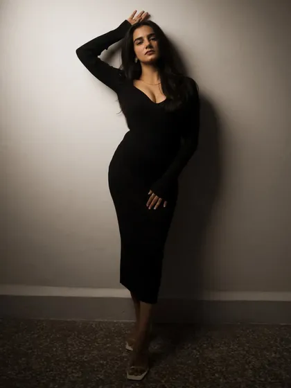 A studio session with a model in a black dress, showcasing a range of poses from pensive to powerful. The lighting is controlled to sculpt the subject and create a sophisticated mood.