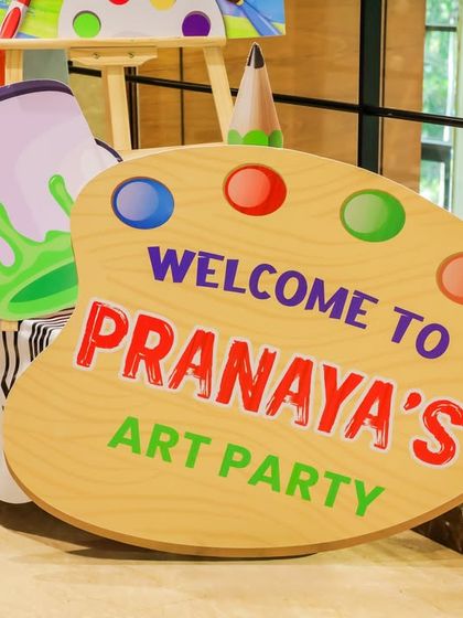 It's all in the details! A custom-made welcome sign in the shape of an artist's palette clearly announces the theme and adds a personalized touch to the party decor.