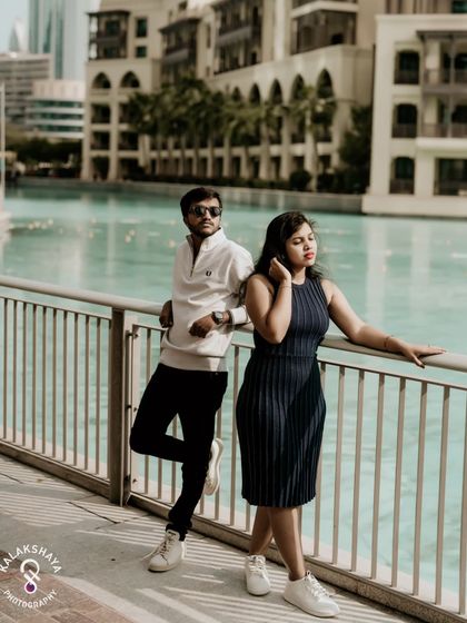Posed against the railing with the beautiful architecture and water in the background, this shot has a relaxed, urban feel.