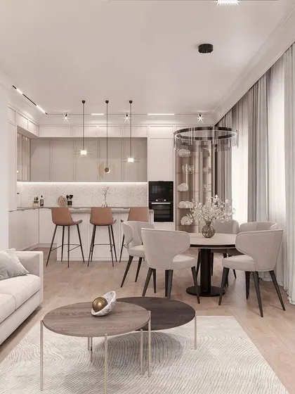 From this angle, you can see how the kitchen's bar seating provides a casual dining option, while the main dining table is set for more formal meals. This dual functionality makes the space versatile for both quick breakfasts and dinner parties.
