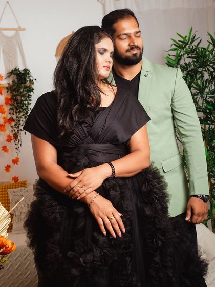 A quiet and romantic moment captured during a couple's photoshoot. The focus is on their connection, with the stylish black gown adding a touch of elegance.