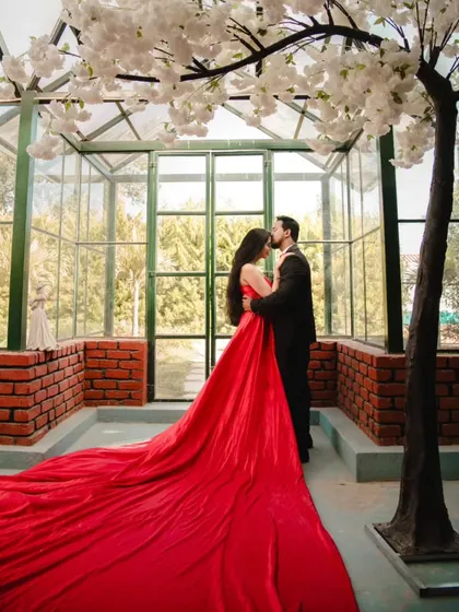 Creating fairytale moments is my specialty. For this romantic pre-wedding shoot, I provided the magnificent red trail gown and a classic tuxedo, ensuring the couple looked perfect in this beautiful glasshouse setting.