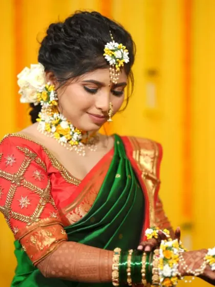 A delicate pose showing the beautiful floral hand jewellery, a key element of the Haldi look.