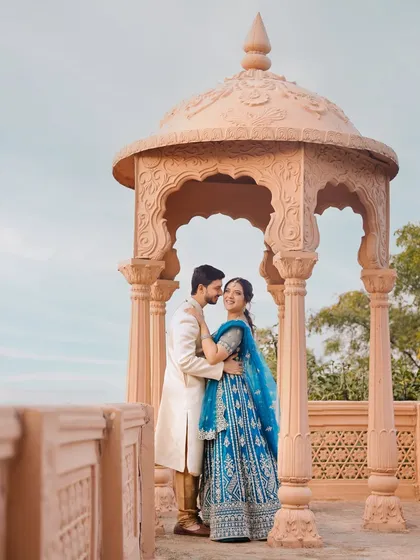 A moment of regal romance from a pre-wedding shoot. I styled the couple in coordinated traditional outfits, with the bride in a striking blue lehenga and the groom in a classic ivory sherwani, creating a timeless look against the beautiful Indian architecture.
