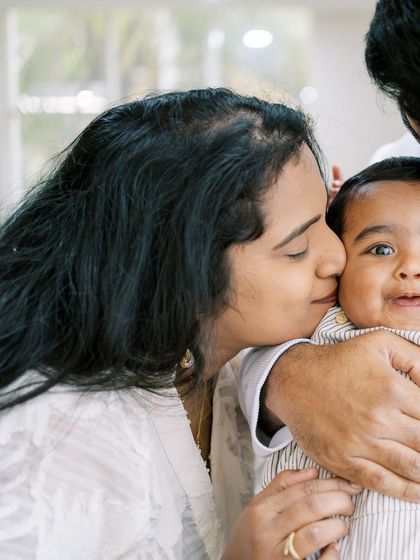 A mother kissing her baby's cheek. These close-up shots are perfect for capturing the sweet details and emotions.
