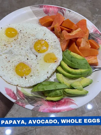 A simple, nutrient-dense meal of papaya, avocado, and four sunny-side-up eggs. This is great for getting in protein, healthy fats, and micronutrients.