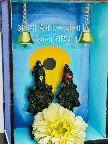 A closer look at the custom wooden mandir for Ashadhi Ekadashi, showing the details of the Vitthal-Rukmini idols and the hand-painted background.