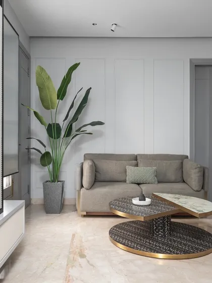 A cozy seating nook in the master bedroom, perfect for quiet moments. The design uses a neutral palette and natural elements to create a calm and inviting space.