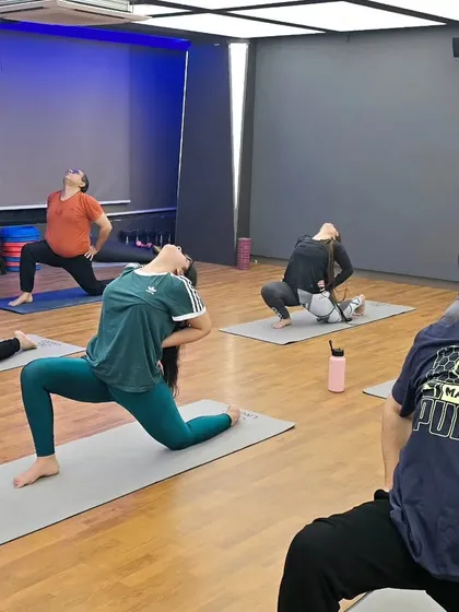 Practicing Anjaneyasana (Low Lunge). This pose provides a deep stretch for the hip flexors, strengthens the legs, and improves overall balance and stability.