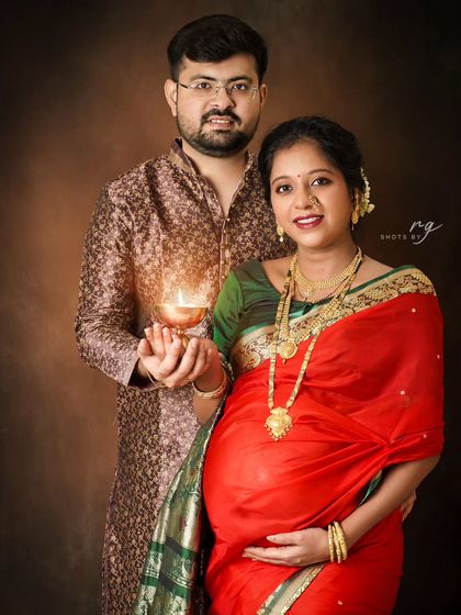 Holding a diya together, this couple symbolizes the light and hope their new baby brings. This is a deeply meaningful pose we love to create during our traditional maternity shoots.