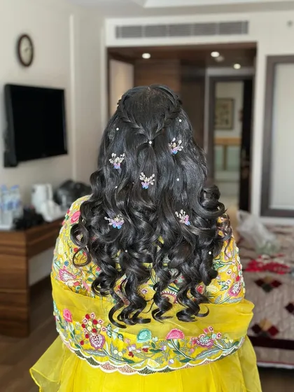 Another angle of the playful Haldi hairstyle, showing the mix of pearls and butterflies.