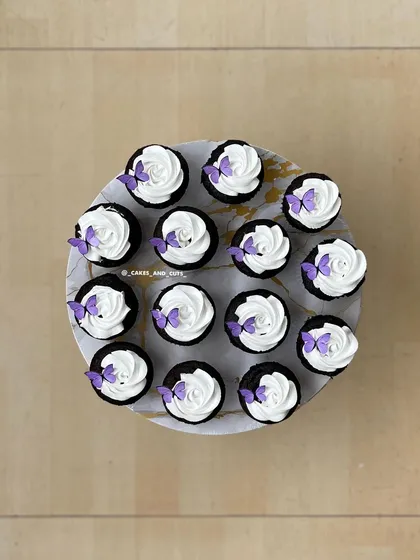 A top-down view of our butterfly cupcakes, each adorned with a delicate purple butterfly.