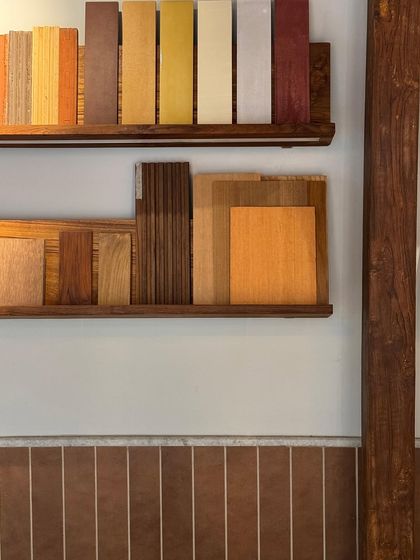 Our material library, with shelves displaying various wood veneers and samples. This is a key part of our studio, allowing us and our clients to touch and feel the materials that will shape their space.