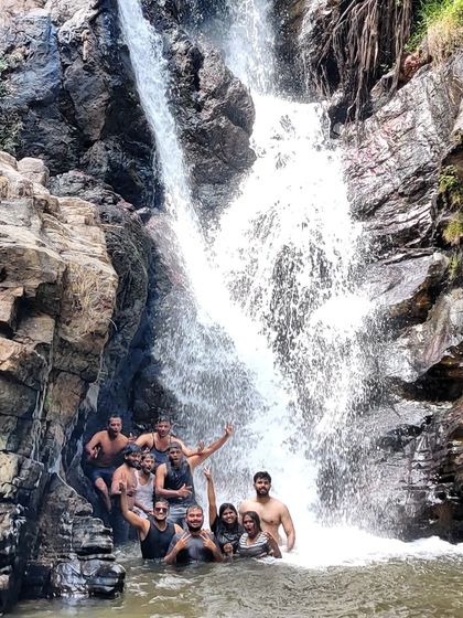 A group enjoying a waterfall dip during a long weekend trip to Chikmagalur.
