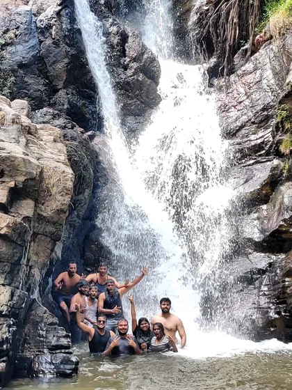 Our group enjoying the cool waters of a waterfall on our Explore Chikmagalur trip.