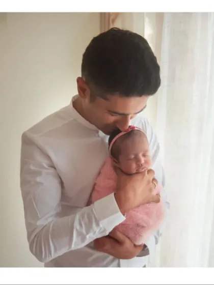 A father cradling his newborn daughter. I always encourage dads to be part of the session; these moments of them holding their tiny new baby are incredibly precious.