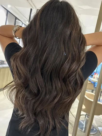 These subtle peek-a-boo highlights are perfect for adding a touch of dimension to long hair. I paired this three-tone color with a long layered haircut to enhance movement.