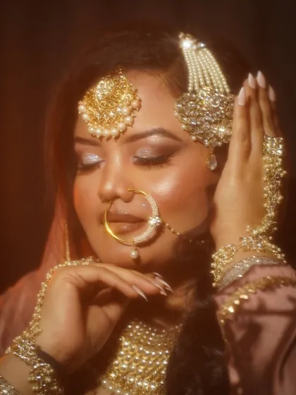 Eyes closed to feature the shimmery eyeshadow, a key element of this festive glam look.