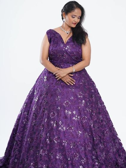 This purple ball gown is covered in delicate floral sequins, creating a beautiful, shimmering effect. It's a perfect choice for anyone wanting to feel like royalty at their event.