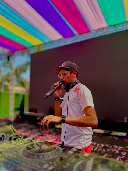 On the mic during a Holi festival performance. These daytime events have a unique, vibrant energy that I love to be a part of.