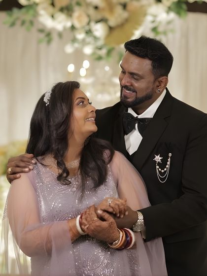 A happy couple portrait. The bride's glam makeup is evident in her radiant smile and sparkling eyes, a perfect look for celebrating with loved ones.