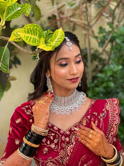 A final touch to Pallavi's reception look. This photo captures the elegance of her pose and the perfection of her makeup.